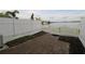 Brick patio with a white privacy fence and views of the lake at 13736 Orange Sunset Dr, Tampa, FL 33618