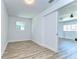 Bright bedroom featuring wood floors, and a sliding door to an adjacent room at 14153 Holiness Church Rd, Dover, FL 33527