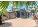 Backyard pool behind a screen fence with partial views of the house at 14501 Brambie Ct, Tampa, FL 33624