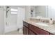 Bathroom with a single sink, dark wood cabinets, and a shower/tub combo with a white shower curtain at 14501 Brambie Ct, Tampa, FL 33624