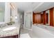 Bathroom boasts double sinks with granite countertops, and a shower with an attached soaking tub at 14501 Brambie Ct, Tampa, FL 33624