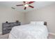 The neutral bedroom has carpet flooring, a ceiling fan, and a dresser with a dark, rustic finish at 14501 Brambie Ct, Tampa, FL 33624