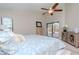 Bright bedroom features a ceiling fan, sliding glass doors to the pool area, and neutral walls at 14501 Brambie Ct, Tampa, FL 33624