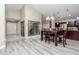 Open-concept dining area featuring modern lighting, wood floors, and seamless flow to kitchen at 14501 Brambie Ct, Tampa, FL 33624