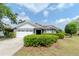 Charming single-story home featuring a well-manicured lawn and an attached two-car garage at 14501 Brambie Ct, Tampa, FL 33624