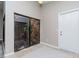 Entryway features a glass-enclosed atrium and neutral tile flooring at 14501 Brambie Ct, Tampa, FL 33624