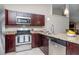 Kitchen featuring stainless steel appliances, granite countertops, and modern fixtures at 14501 Brambie Ct, Tampa, FL 33624
