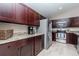 Updated kitchen features granite countertops, stainless steel appliances, and rich dark wood cabinetry at 14501 Brambie Ct, Tampa, FL 33624
