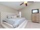 Main bedroom features a plush upholstered platform bed with matching nightstands and dresser at 14501 Brambie Ct, Tampa, FL 33624