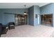 A patio with two chairs is framed by large glass doors with view of the pool and a connected bedroom at 14501 Brambie Ct, Tampa, FL 33624
