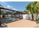 A shot of a lovely pool with a screen enclosure on a clear sunny day at 14501 Brambie Ct, Tampa, FL 33624