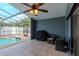 Screened in patio with a pool, and a covered grill, with outdoor seating, and clear blue water at 14501 Brambie Ct, Tampa, FL 33624
