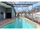 Lovely view of the screened pool with a bright sunny sky shining overhead at 14501 Brambie Ct, Tampa, FL 33624