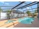 Beautiful sparkling pool and spa with a screened-in lanai overlooking a private backyard at 14501 Brambie Ct, Tampa, FL 33624