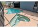 An elevated shot of a screened pool and spa area on a bright sunny day at 14501 Brambie Ct, Tampa, FL 33624