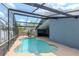 A luxurious pool with a screened-in lanai, perfect for relaxing and entertaining in a private outdoor space at 14501 Brambie Ct, Tampa, FL 33624