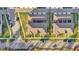 Aerial perspective of townhome roofs, driveways, and street parking in a residential area at 14925 Promenade Pkwy, Odessa, FL 33556