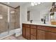 Modern bathroom with dual vanities, walk-in shower, and neutral finishes at 14925 Promenade Pkwy, Odessa, FL 33556