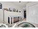 Charming Bedroom with a crib, cozy seating, and a convenient laundry area at 14925 Promenade Pkwy, Odessa, FL 33556