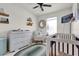 Bright Bedroom with a crib, dresser, and charming decor at 14925 Promenade Pkwy, Odessa, FL 33556