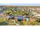 Aerial view features the community clubhouse and pool area with modern architectural design and amenities at 14925 Promenade Pkwy, Odessa, FL 33556