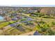 An aerial view shows a Gathering-friendly neighborhood with a playground and lush green spaces for outdoor activities at 14925 Promenade Pkwy, Odessa, FL 33556