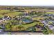 Aerial view showcases a sparkling community pool surrounded by palm trees and ample space for recreation at 14925 Promenade Pkwy, Odessa, FL 33556