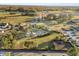 Aerial view showcases a sparkling community pool surrounded by palm trees and ample space for recreation at 14925 Promenade Pkwy, Odessa, FL 33556
