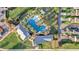Aerial view displays the community pool nestled amongst palm trees, offering a tranquil escape for residents at 14925 Promenade Pkwy, Odessa, FL 33556