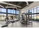 Bright gym with treadmills and equipment under a high ceiling and big windows at 14925 Promenade Pkwy, Odessa, FL 33556