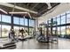 Bright gym with treadmills and equipment under a high ceiling and big windows at 14925 Promenade Pkwy, Odessa, FL 33556