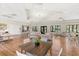Large community room with neutral color palette, light wood floors and lots of seating at 14925 Promenade Pkwy, Odessa, FL 33556