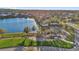 An aerial view shows a scenic pond, playground, and walking path creating a serene recreational space at 14925 Promenade Pkwy, Odessa, FL 33556