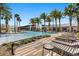 Pool with clubhouse, palm trees, and lounge seating at 14925 Promenade Pkwy, Odessa, FL 33556