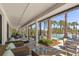 Covered pool deck with tables, chairs, and pool view at 14925 Promenade Pkwy, Odessa, FL 33556