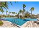 Community pool deck surrounded by palm trees at 14925 Promenade Pkwy, Odessa, FL 33556