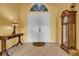 Elegant foyer featuring tile flooring, a decorative table, and a grandfather clock at 1602 Brilliant Cut Way, Valrico, FL 33594