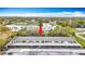 Aerial view of a condominium complex with a large parking area and tree-lined streets at 1655 S Highland Ave # G164, Clearwater, FL 33756