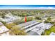Aerial view showcasing a condominium complex with surrounding lush greenery and neighborhood streets at 1655 S Highland Ave # G164, Clearwater, FL 33756
