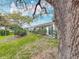 Manicured backyard with mature landscaping providing shade and privacy to the back of the home at 1655 S Highland Ave # G164, Clearwater, FL 33756