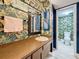 Stylish half-bath featuring colorful wallpaper, a wooden vanity, and a modern light fixture, creating a vibrant space at 1655 S Highland Ave # G164, Clearwater, FL 33756