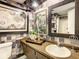 Stylish bathroom with unique wallpaper, decor and vanity with sink at 1655 S Highland Ave # G164, Clearwater, FL 33756