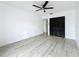 Bright bedroom featuring sleek floors, ceiling fan and closet at 1655 S Highland Ave # G164, Clearwater, FL 33756