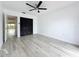 This bedroom features light gray floors, a ceiling fan, and a closet behind louvered doors at 1655 S Highland Ave # G164, Clearwater, FL 33756