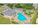 Aerial view of a sparkling blue community pool, surrounded by lounge chairs and landscaping at 1655 S Highland Ave # G164, Clearwater, FL 33756