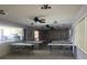 A community room features tables, chairs, and a partial view of the kitchen at 1655 S Highland Ave # G164, Clearwater, FL 33756