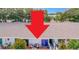 A condo exterior with a back patio, chairs, and sliding glass doors at 1655 S Highland Ave # G164, Clearwater, FL 33756