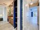 Open hallway leading to a stylish bathroom with open closet space and a bedroom with natural light, creating an inviting flow at 1655 S Highland Ave # G164, Clearwater, FL 33756