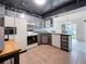 Bright kitchen featuring ample cabinetry, a tiled backsplash, and modern appliances at 1655 S Highland Ave # G164, Clearwater, FL 33756