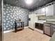 Kitchen features unique wallpaper, stainless steel appliances, and ample counter space at 1655 S Highland Ave # G164, Clearwater, FL 33756